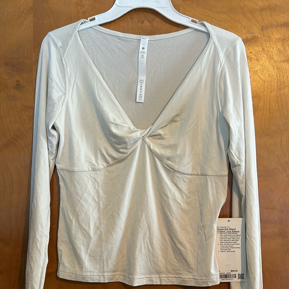 modal-blend long sleeve has a deep v-neckline and a twist-front detail